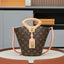 Louis Vuitton monogram canvas bucket bag with a top handle, lock detail, and red piping on the strap, displayed on a round pedestal.