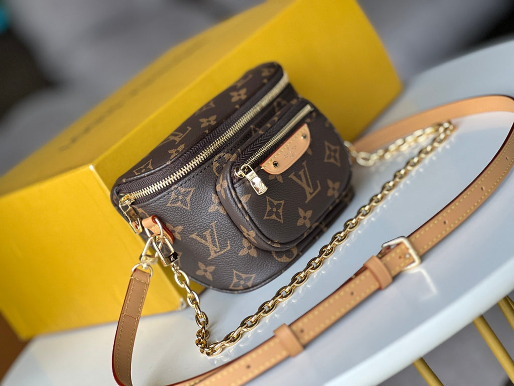 Designer handbag with monogram pattern on a yellow box