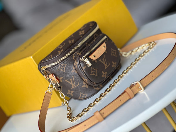 Designer handbag with monogram pattern on a yellow box