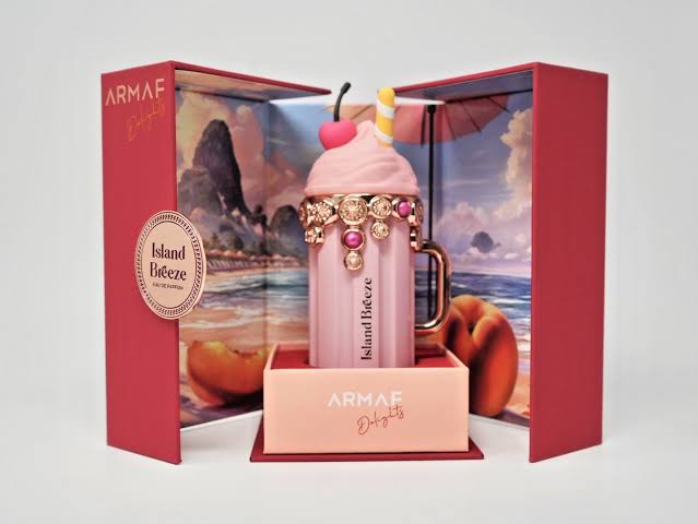 Pink ice cream-themed perfume bottle with decorative elements in an open Armaf box.