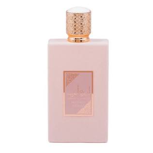 A pale pink rectangular perfume bottle with a textured rose gold cap and a matching rose gold label on the front, set against a plain white background.