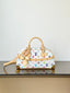 A Louis Vuitton monogram handbag in white coated canvas with multicolor printed monogram motifs, tan leather handles and trim, and gold-tone hardware, displayed on a reflective surface against a plain light background.